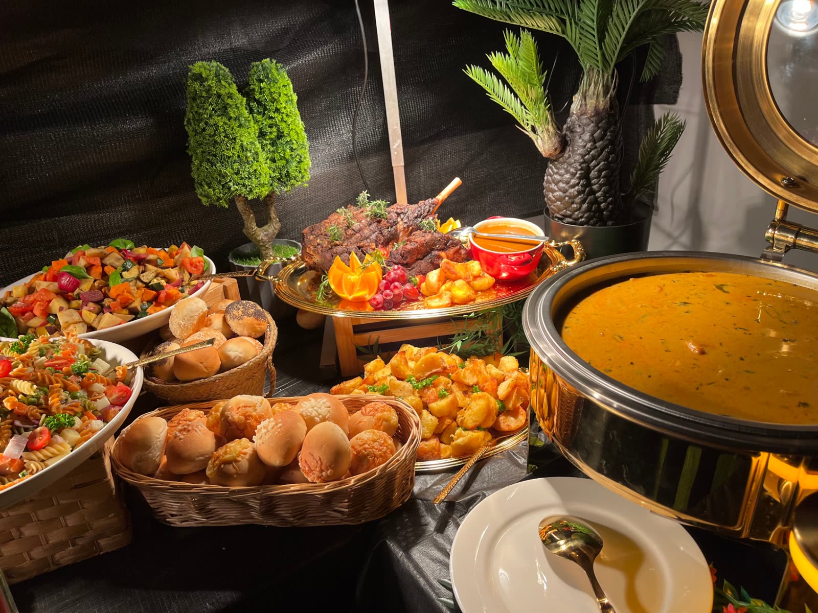Roast lamb centrepiece with pumpkin soup, salads and fresh bread rolls