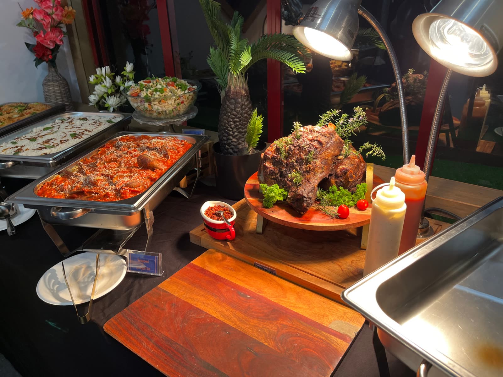 Roast lamb leg with seafood spaghetti buffet display